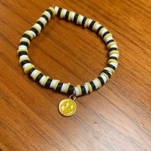 Clay bead bracelet with metal smiley face charm